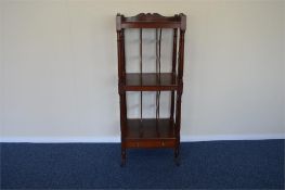 An Antique mahogany what-not on turned supports. Est. £400 - £500.