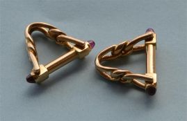 A pair of French cufflinks in the form of stirrups with cabouchon ruby mounts. Est. £300 - £350.