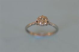 A small platinum and 18ct diamond single stone ring. Est. £240 - £260.