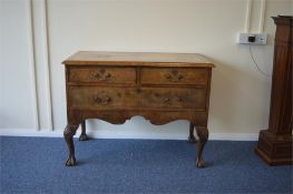A walnut three drawer chest on ball and claw feet with brass handles. Est. £120 - £140.