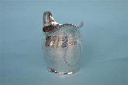 A George III bright cut cream jug. London 1806. Est. £170 - £200.