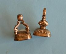 Two Antique seals with reeded decoration and loop top. Est. £30 - £40.