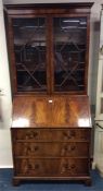 A good mahogany glazed bureau bookcase with fitted interior on bracket feet. Est. £380 - £420.