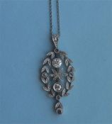 An attractive Edwardian platinum and diamond drop pendant with central flower and loop top on fine