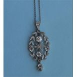 An attractive Edwardian platinum and diamond drop pendant with central flower and loop top on fine