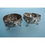 A pair of Indian three legged salts decorated with flowers and leaves. Approx. 105 grams. Est. £20 -