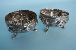 A pair of Indian three legged salts decorated with flowers and leaves. Approx. 105 grams. Est. £20 -