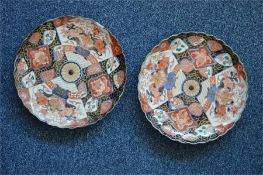 Two Imari plates. Approx. 30 cms in diameter. (Chip on one of the plates.) Est. £20 - £30.