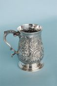 A George III pint tankard, heavily embossed with flowers and leaves. London 1763. By George