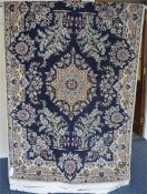 An Indian rug with medallion on white background. Approx. 195 cms x 127 cms. Est. £40 - £60.