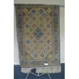 A Persian rug with diamond decoration on ivory background. Approx. 164 cms x 105 cms. Est. £50 - £