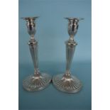 A good pair of half fluted Adams' style candlesticks on oval base with beaded rim. London 1968. By