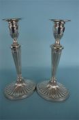 A good pair of half fluted Adams' style candlesticks on oval base with beaded rim. London 1968. By