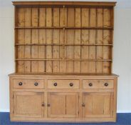 A massive pine kitchen dresser with shelved top and covered base. Approx. 220 cms long x 250 cms