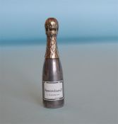 A rare and unusual miniature scent in the form of a champagne bottle with gilt lid and enamelled