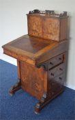 A good Davenport with walnut sloped inlaid top and dummy drawers to one side on turned ball feet.
