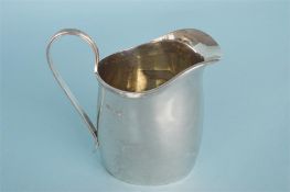 A heavy helmet shaped cream jug of Georgian design with reeded handle. Sheffield 1964. By H&H.