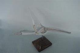 A glass figure of a flying bird with outstretched wings, by Daum of France. Est. £50 - £60.