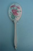 An attractive hand mirror enamelled with pink carnations. Birmingham 1950. By Aide Bros. Est. £120 -