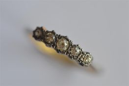 An 18ct and platinum five stone diamond ring. Approx. 3 grams. Est. £40 - £50.