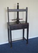 An Antique book press on square tapering supports and single drawer. Est. £100 - £150.