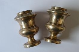 An unusual pair of Georgian salt and pepper pots with pierced top on pedestal bases. London 1717. By