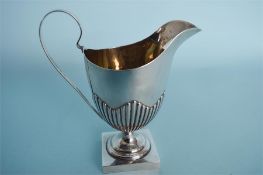 A square based half fluted cream jug. Birmingham. By HP&H. Approx. 120 grams. Est. £60 - £80.