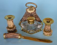 A brass and antler desk set comprising candlesticks, inkwell and letter opener. Est. £250 - £300.