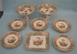 A Meissen style gilt decorated comport together with fourteen matching plates, and a square