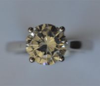 An impressive platinum mounted brilliant cut diamond ring, weighing 2.51 carats, in four claw
