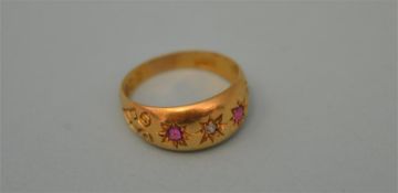A ruby and diamond three stone gypsy set ring in 18ct mount. Approx. 3 grams. Est. £30 - £40.