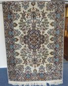 An Indian rug with medallion on white background. Approx. 190 cms x 125 cms. Est. £40 - £60.
