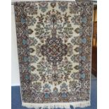 An Indian rug with medallion on white background. Approx. 190 cms x 125 cms. Est. £40 - £60.