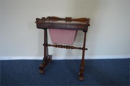 A good quality rosewood sewing table with sliding basket and drawers to side with stretcher base.