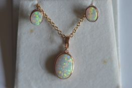 A rose gold opal mounted pendant on fine link chain, together with matching earrings. Approx. 6