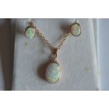 A rose gold opal mounted pendant on fine link chain, together with matching earrings. Approx. 6