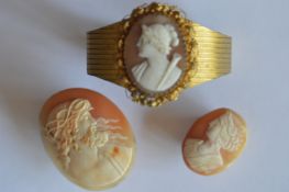 A gilt bracelet mounted with shell cameo in leaf decorated frame together with two other unmounted