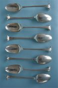 A good set of eight early Georgian dessert spoons with twisted terminals and crested backs.