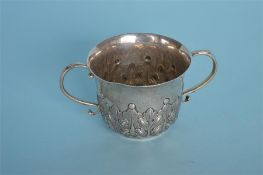 A Georgian style two handled porringer with leaf decoration. London 1897. By CB&H. Approx. 150
