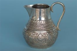 A small helmet shaped cream jug decorated with animals. London 1875. Approx. 65 grams. Est. £30 - £