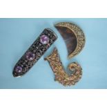 A silver gilt floral decorated hair comb together with a knife sleeve and a ruby mount. Est. £