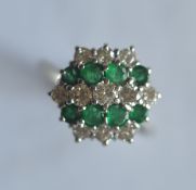 A good quality emerald and diamond five row 19 stone cluster ring in 18ct white gold. Est. £500 - £
