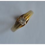 A heavy 18ct single stone diamond gypsy set ring in claw mount. Est. £150 - £200.