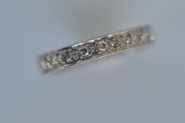 A diamond full eternity ring in white gold. Ring size N. Est. £400 - £500.