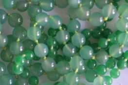 Two rows of graduated jade beads. Est. £50 - £60.