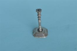 An unusual miniature Continental cast candlestick. Approx. 5 cms high. Est. £80 - £100.
