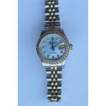 A good lady's stainless steel and gold Rolex wristwatch with gold and diamond bezel and blue MOP