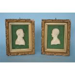 A good pair of carved ivory busts of Napoleon and Josephine in decorative gilt frame and green