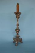 A large impressive continental lamp decorated with scrolls and leaves on three spreading feet.