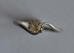 A diamond single stone crossover ring in platinum mount. Approx. 0.25 carats. Est. £250 - £300.